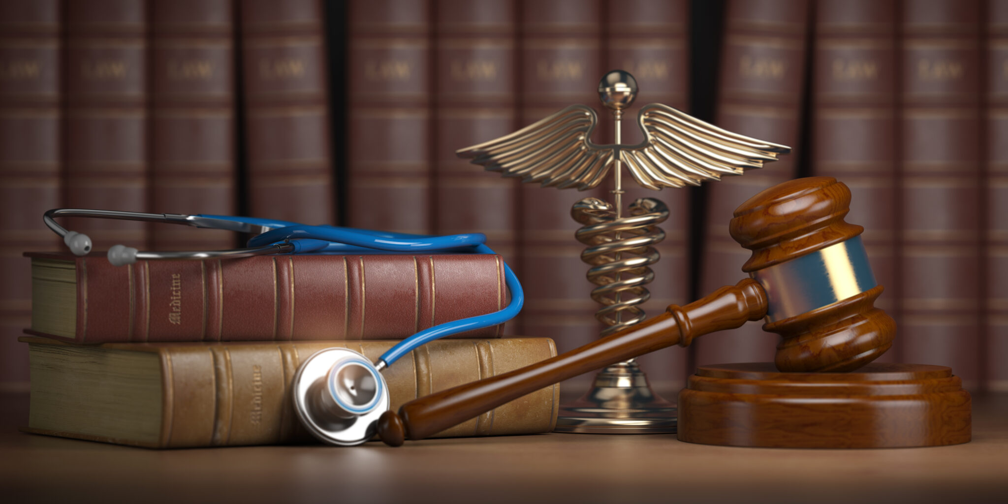 A judge 's gavel, stethoscope and medical symbol on top of books.