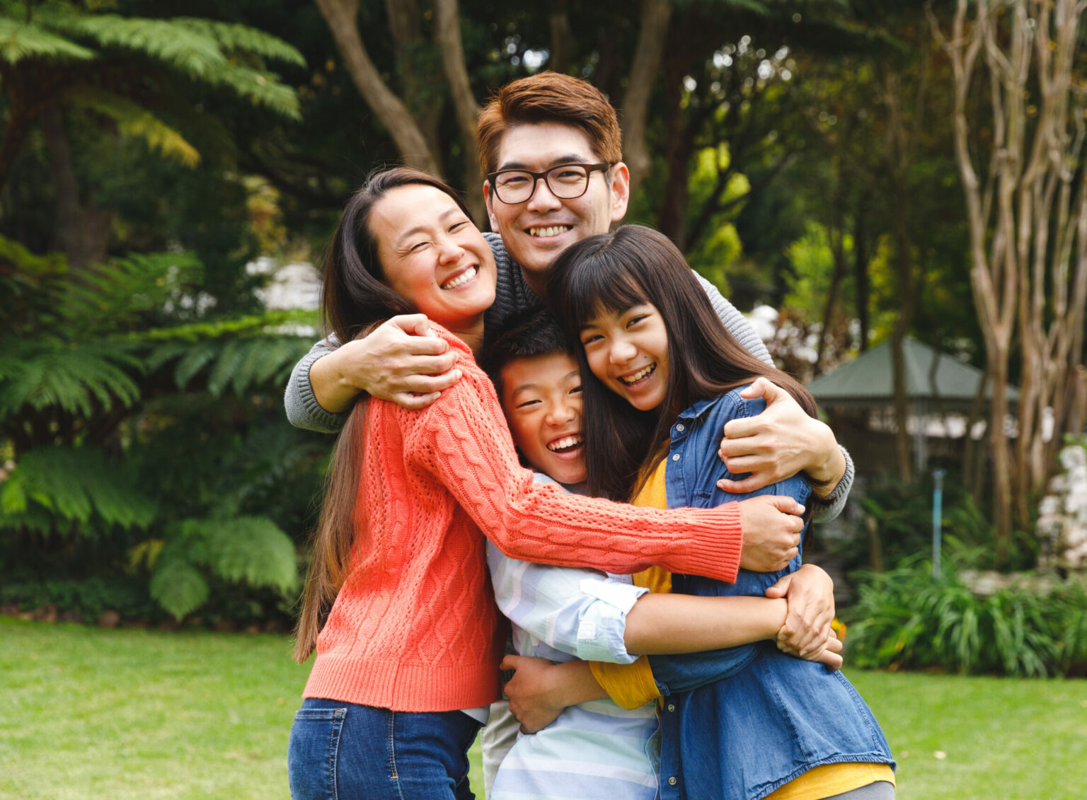 A group of people hugging in the park