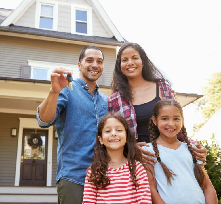 A family standing in front of their home