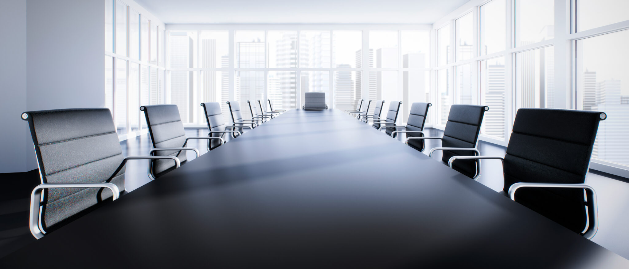 A long table with chairs in front of a window.