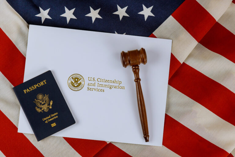 A gavel and passport on top of an american flag.